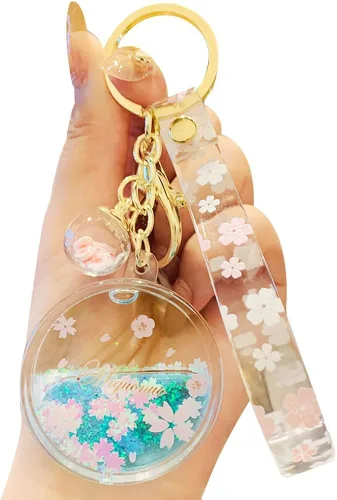Sunfans Llavero para niñas y mujeres, con diseño de flor de cerezo y flores de ensueño, diseño de arena en movimiento